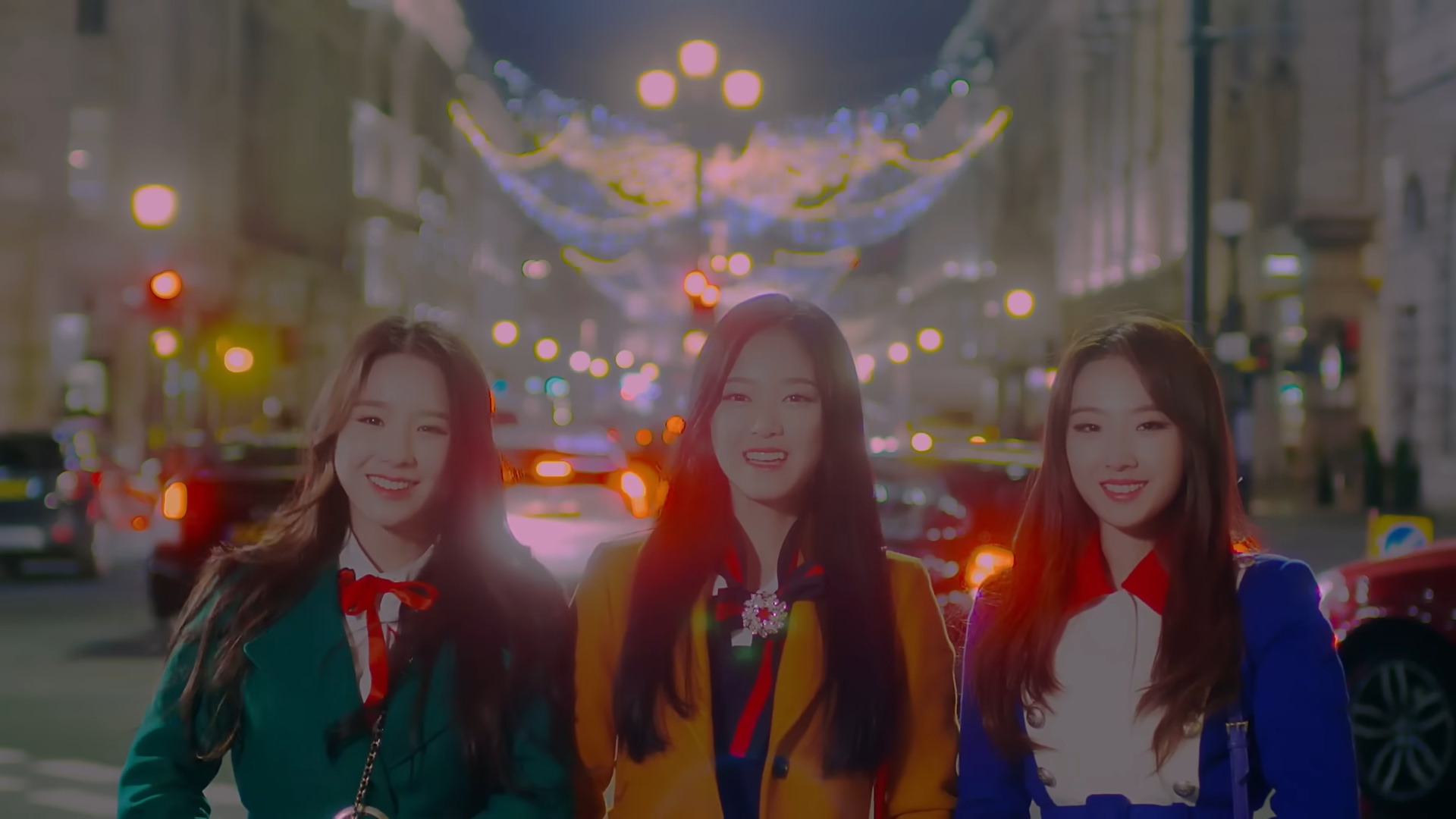 Heejin, Hyunjin, and Haseul smiling from 'The Carol' music video.